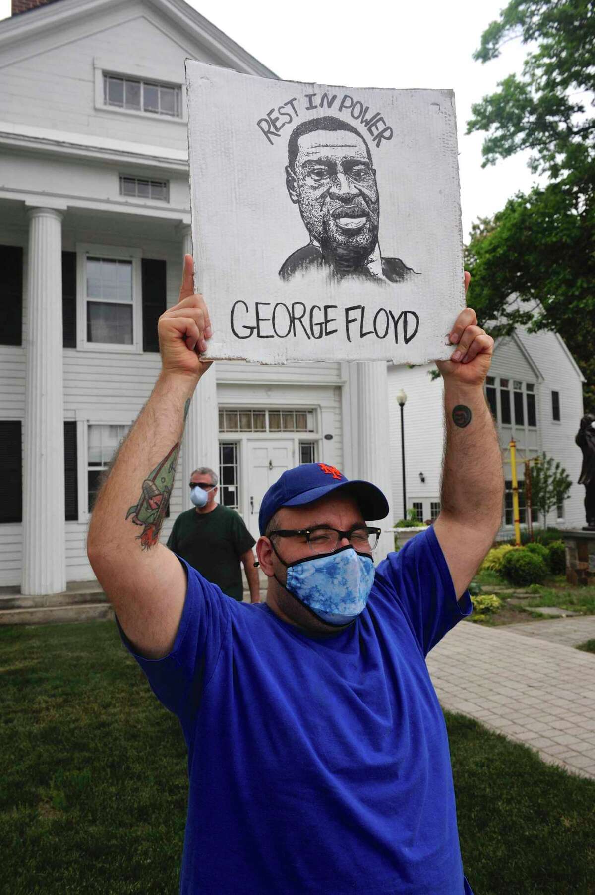 Stephen Colon, of Danbury, holds up a sign he drew for a protest in Bethel on Thursday evening. Due to coronavirus concerns a candlelight vigil, for justice in the wake of the death of George Floyd, in front of the municipal center was postponed. People gathered anyway in front of the Bethel Library. Thursday evening, June 4, 2020, in Bethel, Conn.