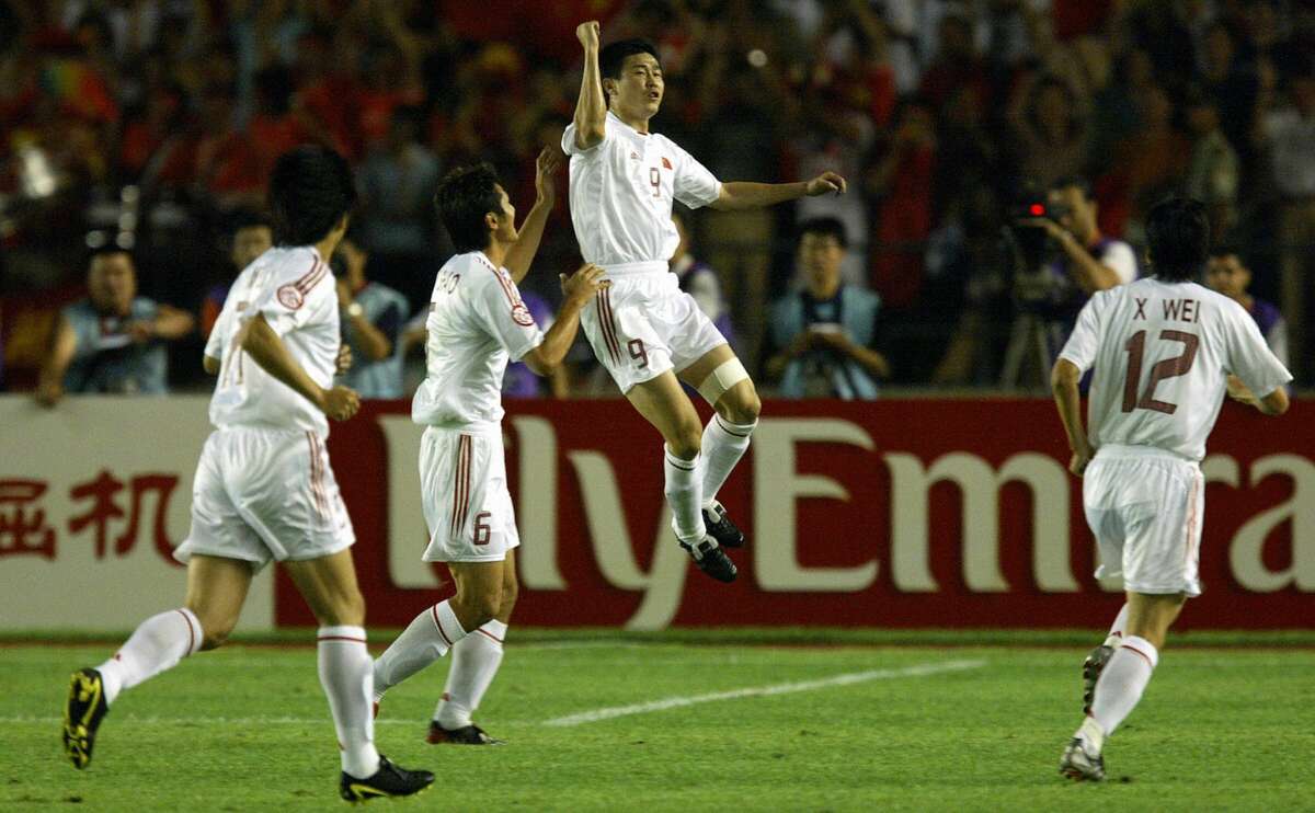 BEIJING, CHINA: China's Hao Haidong (2-R) celebrates his goal with teamates after opening the scoring against Iraq in their quarter-final game in the 2004 Asian Cup Soccer tournament at the Workers Stadium in Beijing, 30 July 2004.