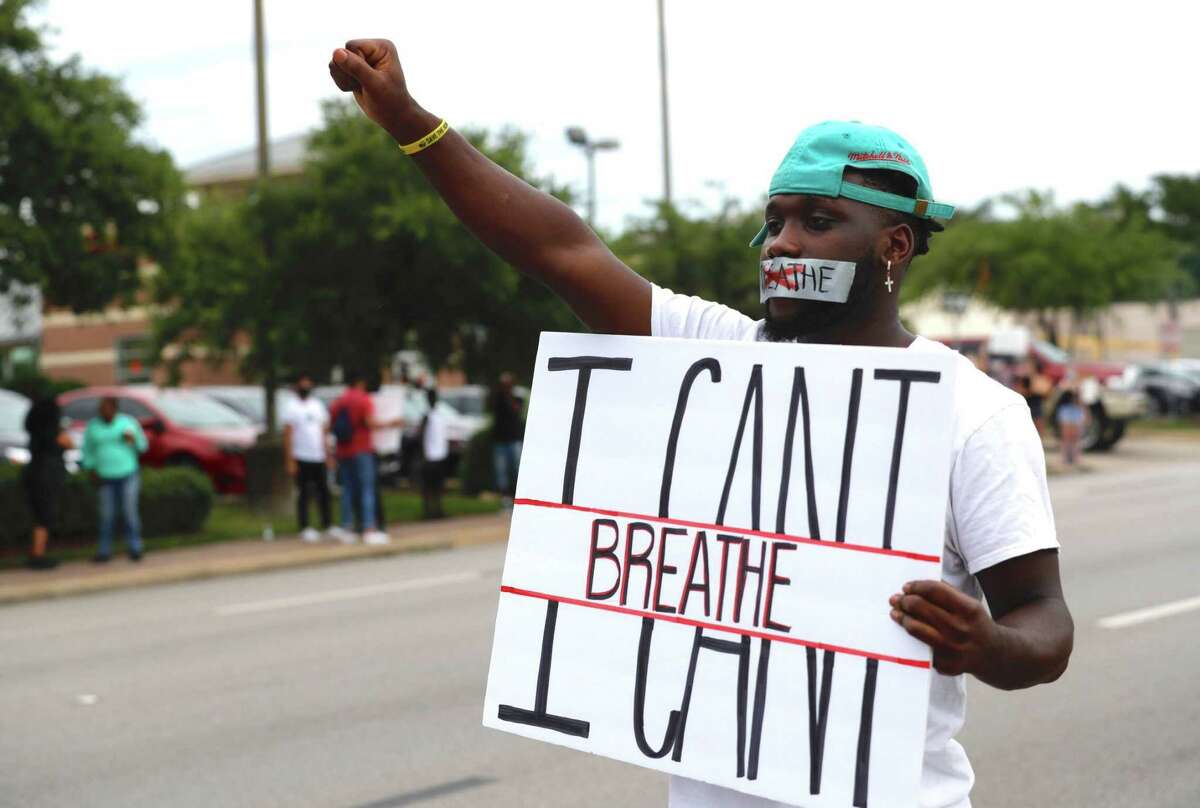 Von Gardner is seen with tape over his mouth while holding his fist into the air as he and others protest the death of George Floyd at Frazier Street and West David Street, Sunday, May 31, 2020, in Conroe. Floyd, originally from Houston, died while he was in the custody of Minneapolis police last week, which has sparked protests throughout the country.