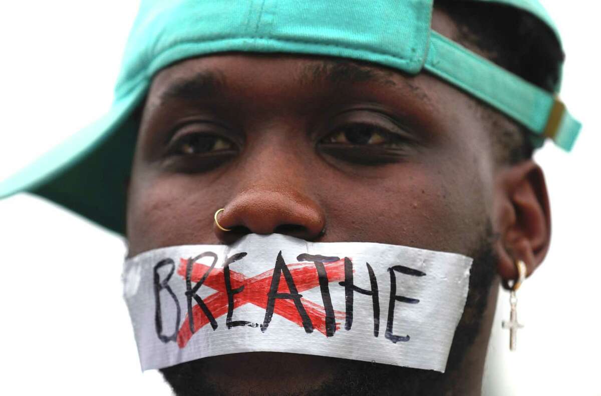 Von Gardner is seen with tape over his mouth as he and others protest the death of George Floyd at Frazier Street and West David Street, Sunday, May 31, 2020, in Conroe. Floyd, originally from Houston, died while he was in the custody of Minneapolis police last week, which has sparked protests throughout the country.