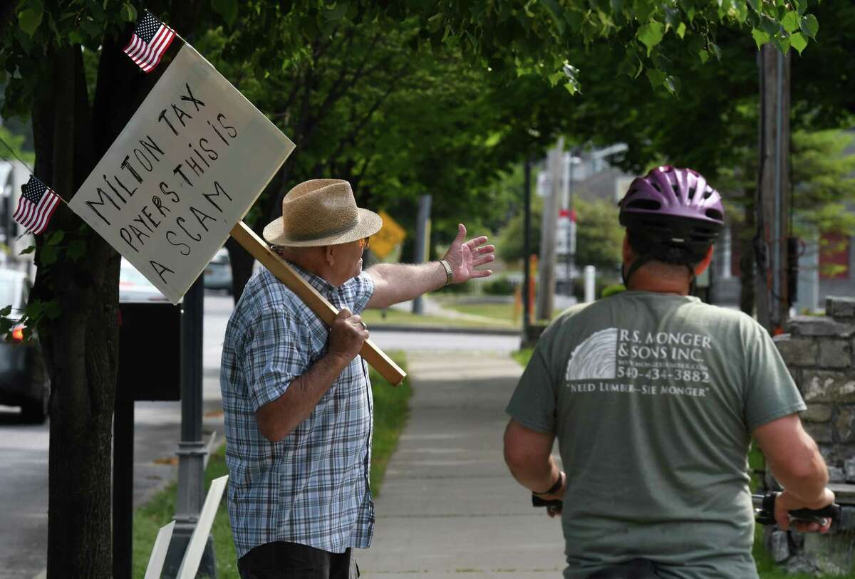 Jim Staulters, left, speaks to a passerby while protesting outside Milton Town Hall on Friday, June 5, 2020, in Milton, N.Y. Staulters is skeptical about the recent condemning of the town building by a town inspector. (Will Waldron/Times Union)