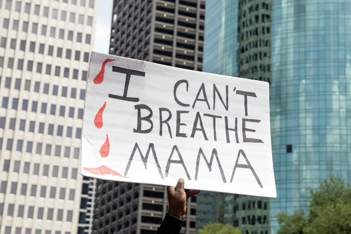 Protestors march at a Black Lives Matter event rally honoring George Floyd.