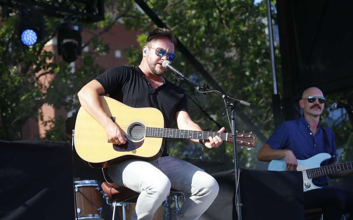 Mike Eli, left, and Jon Jones perform in the parking lot outside of Globe Life Field in Arlington, Texas, Thursday, June 4, 2020. The The Eli Young Band performed as part of the Concert in Your Car series at the new Texas Rangers stadium.(AP Photo/LM Otero)