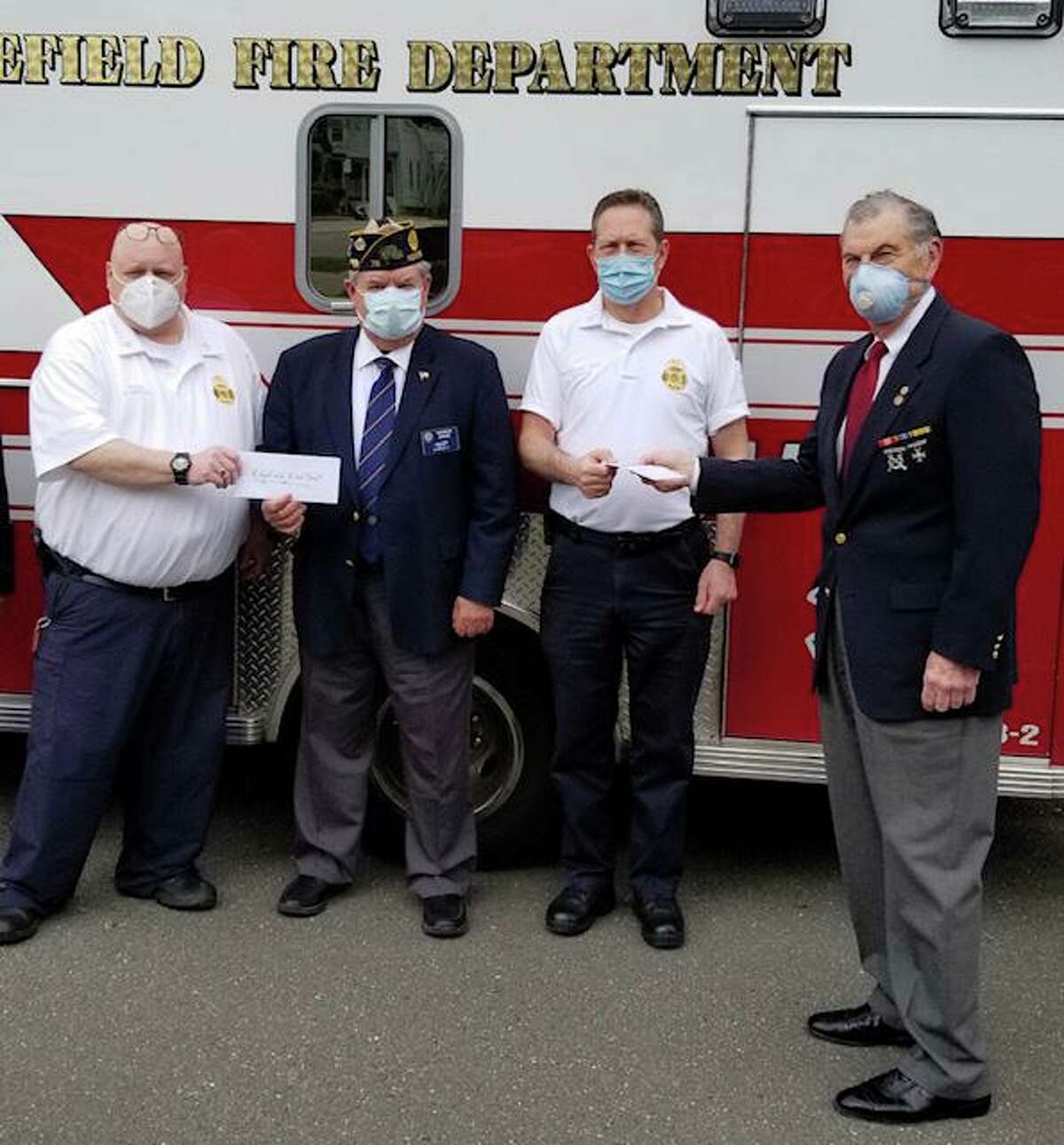 The Marine Veterans of Fairfield County and The Ridgefield American Legion each gave a check for $1,000 to the Ridgefield Fire Departments. Pictured are Fire Chief Jerry Myers; Ridgefield American Legion Commander George Besse; Assistant Fire Chief Michael Grasso; and Dick Tiani of the Marine Veterans of Fairfield County.