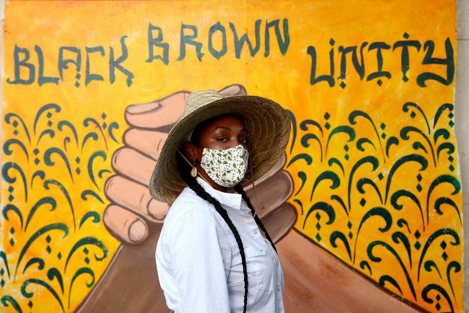 Alysa Wilson, 31, of Oakland, poses for a portrait in front of the Black Brown Unity mural at 14th and Broadway during a George Floyd protest at Frank Ogawa Plaza in Oakland, Calif., on Thursday, June 4, 2020. Floyd, a 46-year-old Black man, was killed by a Minneapolis police officer last week. Photo: Yalonda M. James / The Chronicle