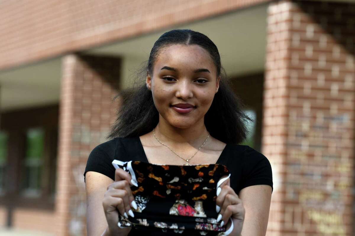Graduating Schenectady High School senior Kini-Analysa McCalmon is pictured outside her school on Thursday, June 4, 2020, in Schenectady, N.Y. Kini-Analysa made face masks and assisted her community in overcoming coronavirus hardships. (Will Waldron/Times Union)