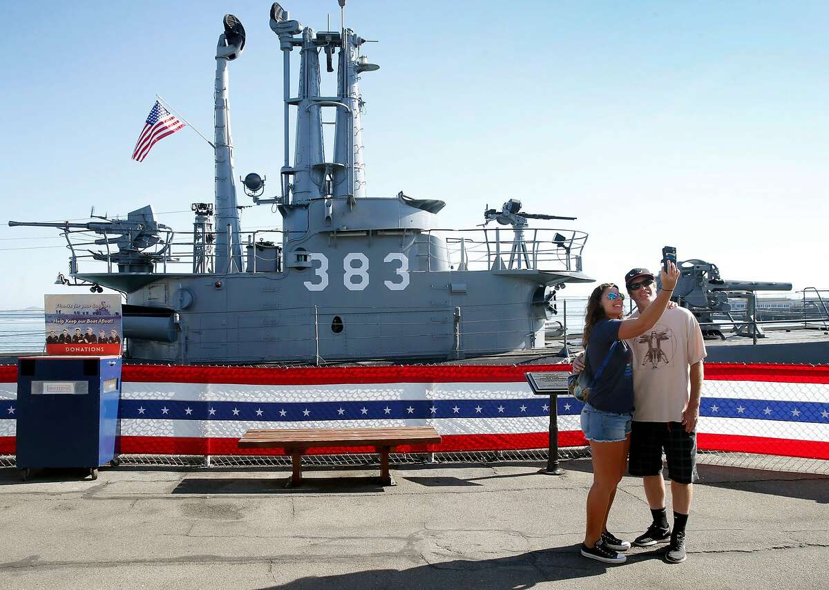 Visitors snap a selfie with the World War II submarine USS Pampanito at Pier 45 in San Francisco, Calif. on Friday, Sept. 13, 2019. The Pampanito rescued 73 prisoners of war left for dead after the Japanese ship they were aboard was torpedoed 75-years ago.