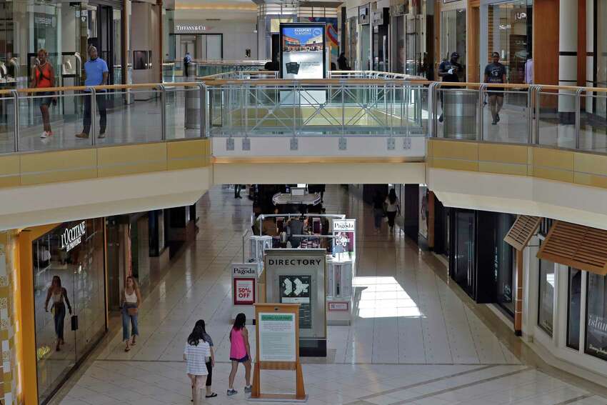 FILE - In this May 6, 2020 file photo, shoppers walk outside stores at the International Mall in Tampa, Fla. Usually, when you stop buying something you used to buy regularly, ita€™s a big sacrifice. But cutting things out of your budget doesna€™t always have to be a bad thing. Scaling back shopping habits can come with unexpected benefits, such as fewer deliveries to track and more money left at the end of the month. (AP Photo/Chris O'Meara, File)