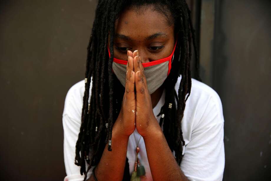 Tiphereth Banks opens her eyes for a moment during a photo shoot near 13th and Broadway in Oakland, Calif., on Friday, June 5, 2020. Banks, an artist and student, is painting a mural a block away. Artists have been creating art to remember George Floyd and other Black people murdered by policer other injustices. Floyd, a 46-year-old Black man, was killed by a Minneapolis police officer last week. Photo: Yalonda M. James / The Chronicle