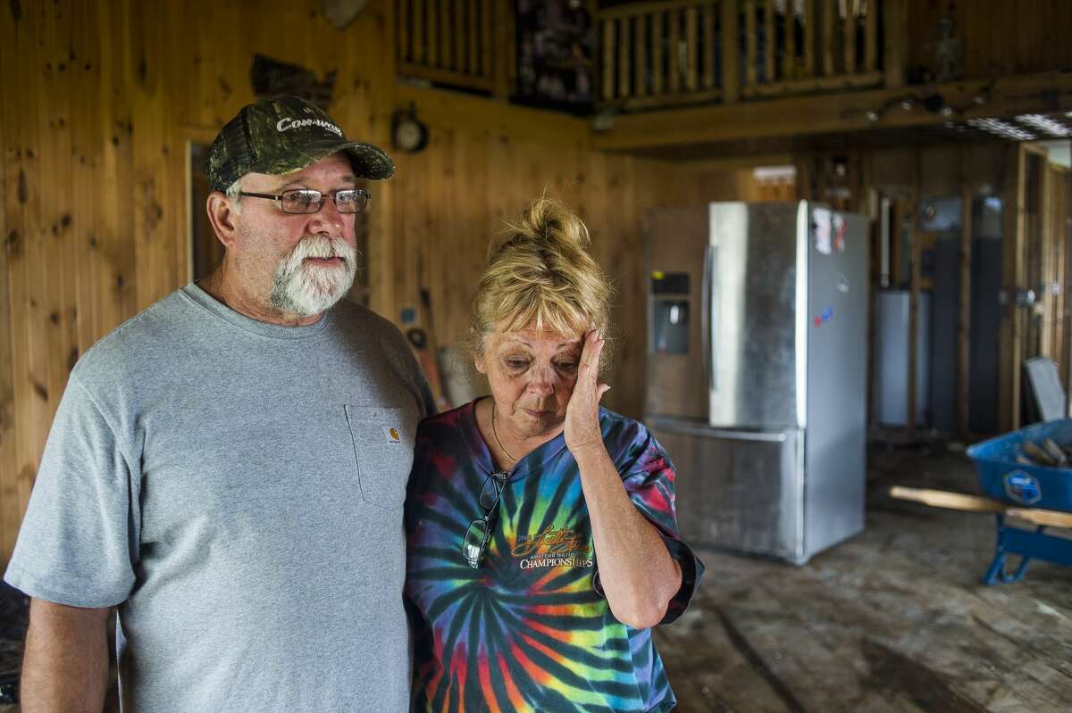 Larry and Rochelle Phillips pose for a portrait in their home on N. Verity Road as volunteers from Samaritan's Purse assist them Friday, June 5, 2020 in stripping the structure of building materials damaged by flooding. (Katy Kildee/kkildee@mdn.net)