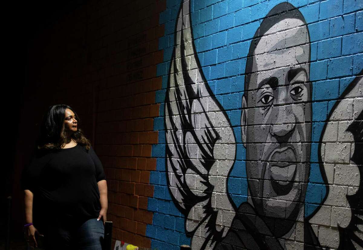 Tiffany Cofield visits the mural honoring former Houston resident George Floyd in the Third Ward.