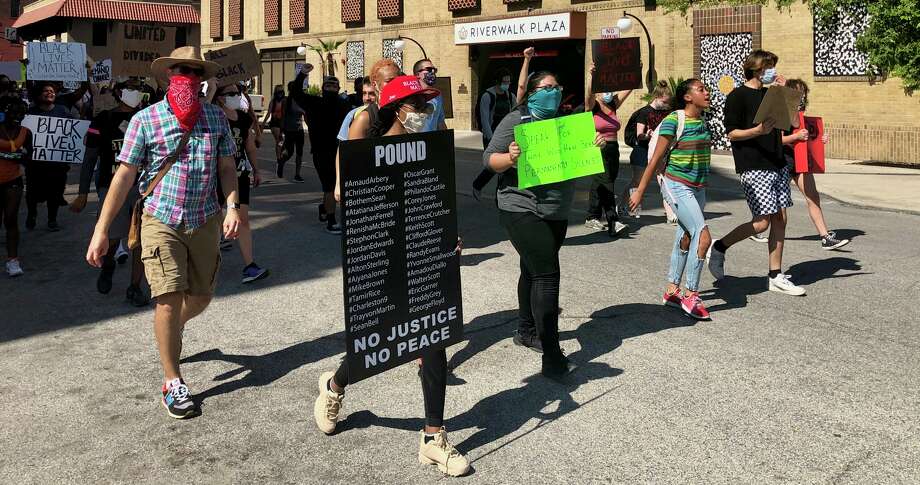 Protesters march from SAPD headquarters around the courthouse and back, shouting the names of black men and women who died in police custody on Saturday afternoon, June 6, 2020.