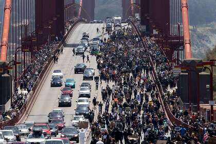 Thousands of demonstrators make their way across the Golden Gate Bridge in San Francisco, Calif. Saturday, June 6, 2020 during a march in support of the Black Lives Matter movement organized by 17-year-old Tiana Day and her father Tiayadi Day of San Ramon.