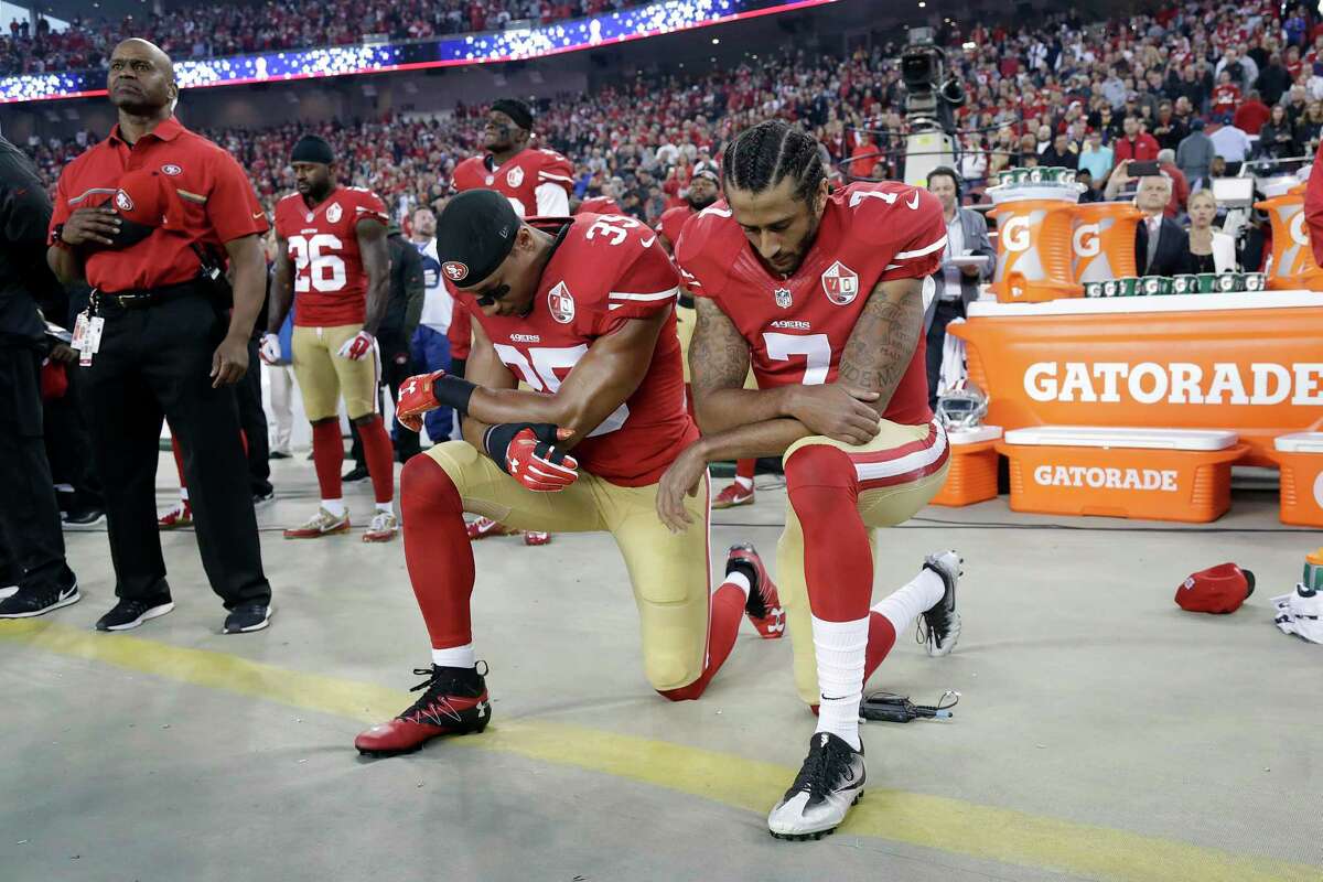 FILE - In this Sept. 12, 2016, file photo, San Francisco 49ers safety Eric Reid (35) and quarterback Colin Kaepernick (7) kneel during the national anthem before an NFL football game against the Los Angeles Rams in Santa Clara, Calif. When Colin Kaepernick took a knee during the national anthem to take a stand against police brutality, racial injustice and social inequality, he was vilified by people who considered it an offense against the country, the flag and the military. (AP Photo/Marcio Jose Sanchez, File)