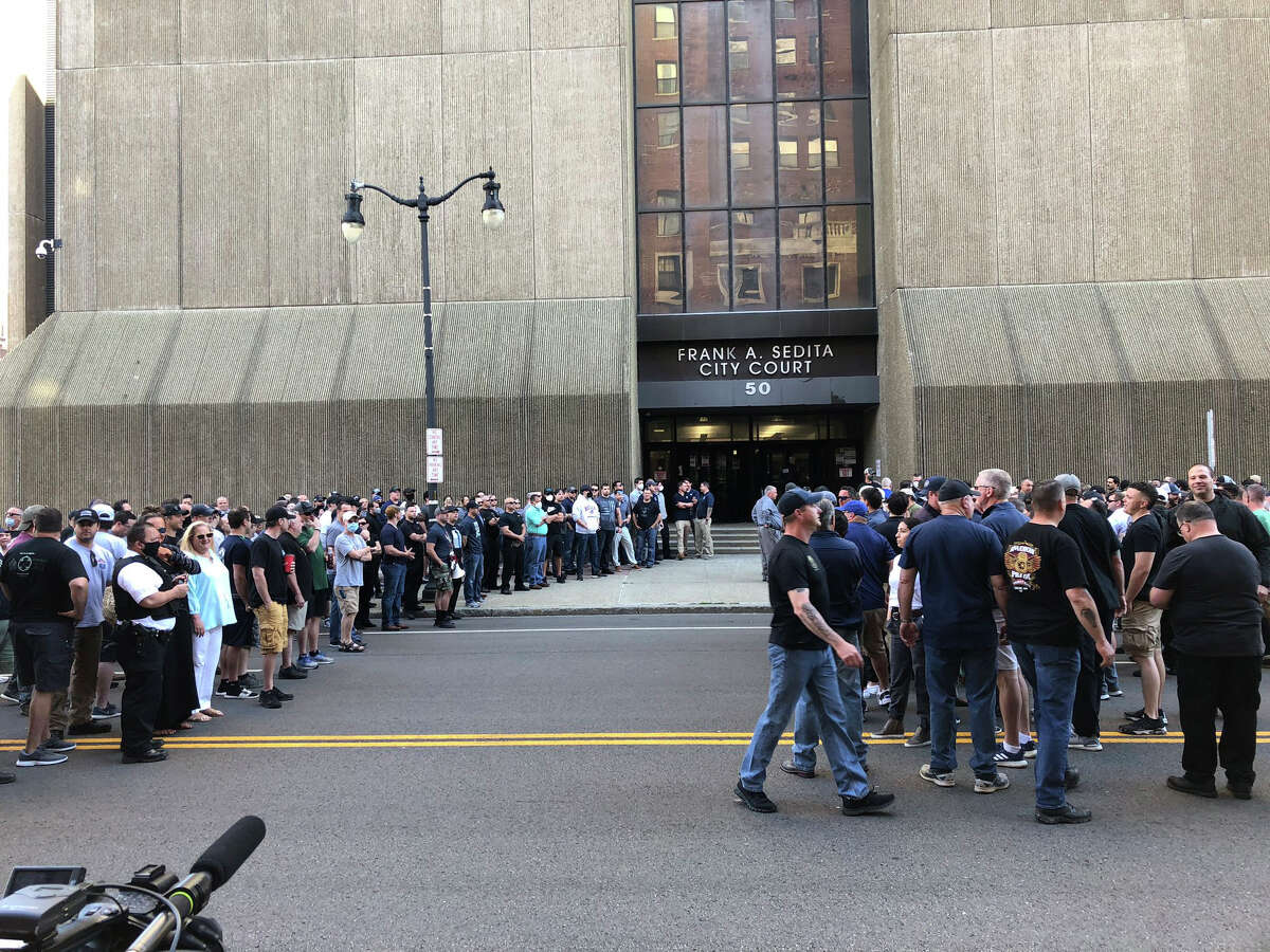 In this photo provided by WKBW, supporters of two suspended Buffalo police officers assemble outside the courthouse in Buffalo, N.Y., Saturday, June 6, 2020. According to prosecutors, both officers were charged with assault Saturday, after a video showed them shoving a 75-year-old protester in a recent demonstration over the death of George Floyd. (Madison Carter/WKBW via AP)