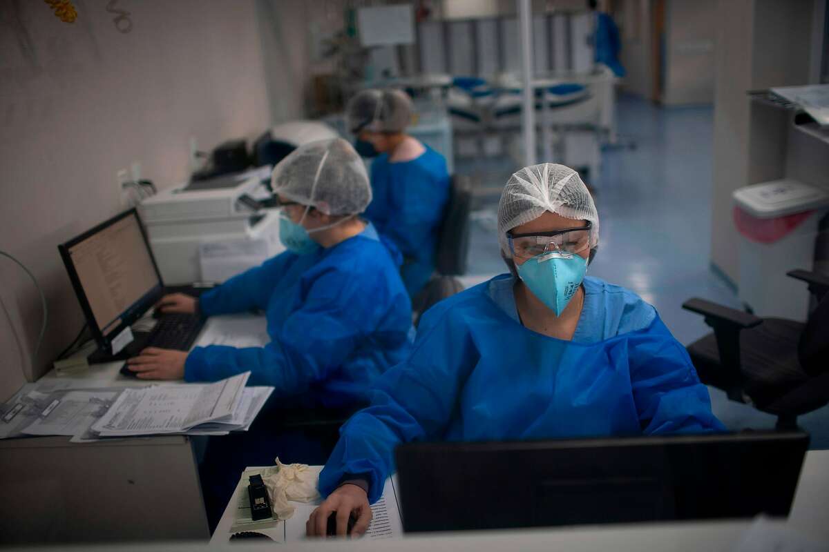 Health professionals work at the Intensive Care Unit (ICU) ward where patients infected with the novel coronavirus, COVID-19, are being treated at the Doctor Ernesto Che Guevara Public Hospital in Marica city, state of Rio de Janeiro, Brazil, on June 5, 2020.