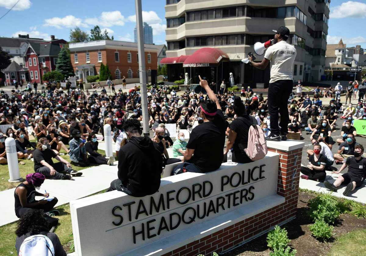 Stamford resident Carl Michel stands and delivers a speech during the Black Lives Matter protest at the Stamford Police Department in Stamford on Sunday.