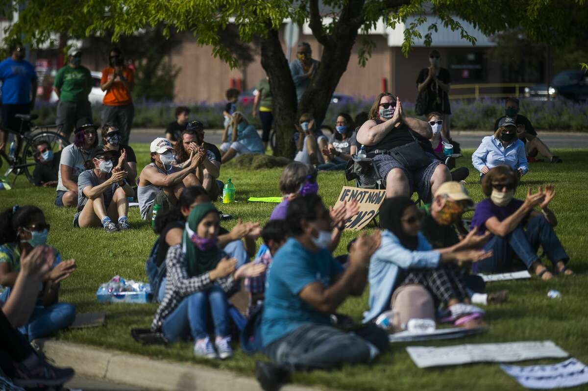 Approximately 1,200 people gather for a rally for racial justice Sunday, June 7, 2020 in Midland. The group gathered at Ashman Circle before marching down Saginaw Road until they reached Eastlawn Drive, turned around and marched back. (Katy Kildee/kkildee@mdn.net)