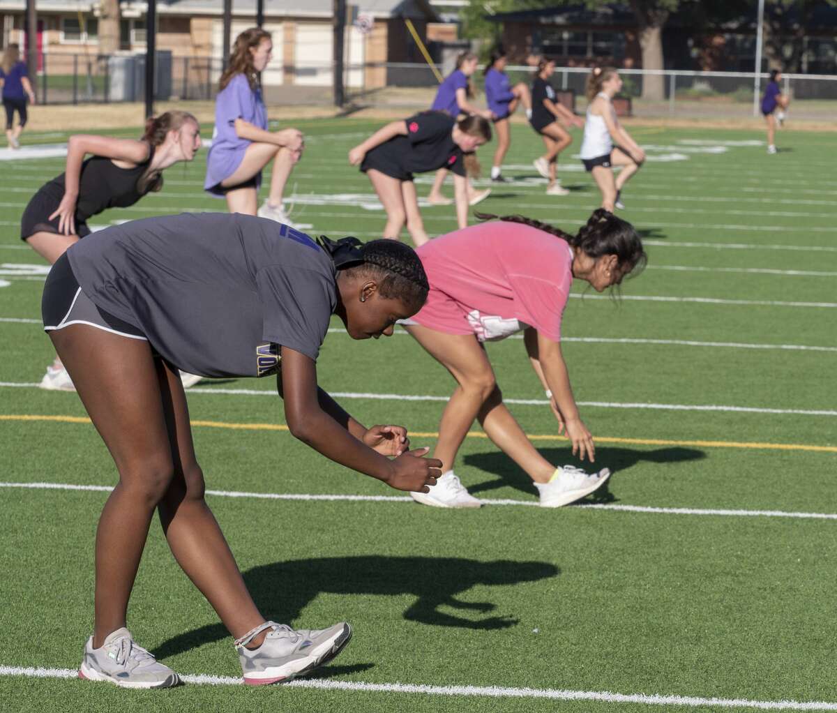 Midland High volleyball players spread out across the turf field at San Jacinto Junior High 06/08/2020 for the first day UIL has allowed organized workouts since mid-March. Tim Fischer/Reporter-Telegram