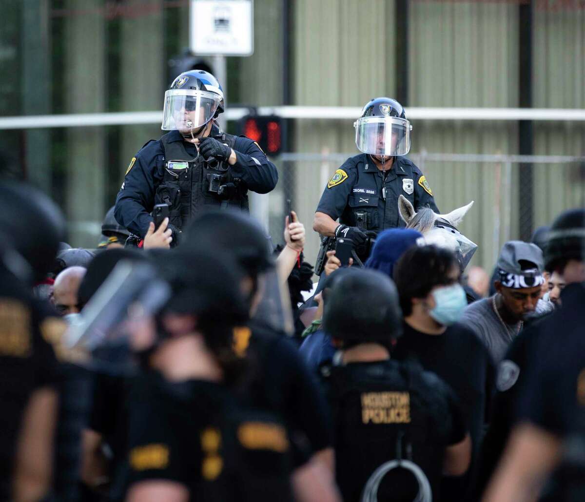 Houston Police Department officers ask demonstrators to leave the premises after they deemed it as a nonpeaceful assembly in downtown Houston, Tuesday, June 3, 2020. An estimated 60,000 people attended the rally in support of George Floyd and police reform.