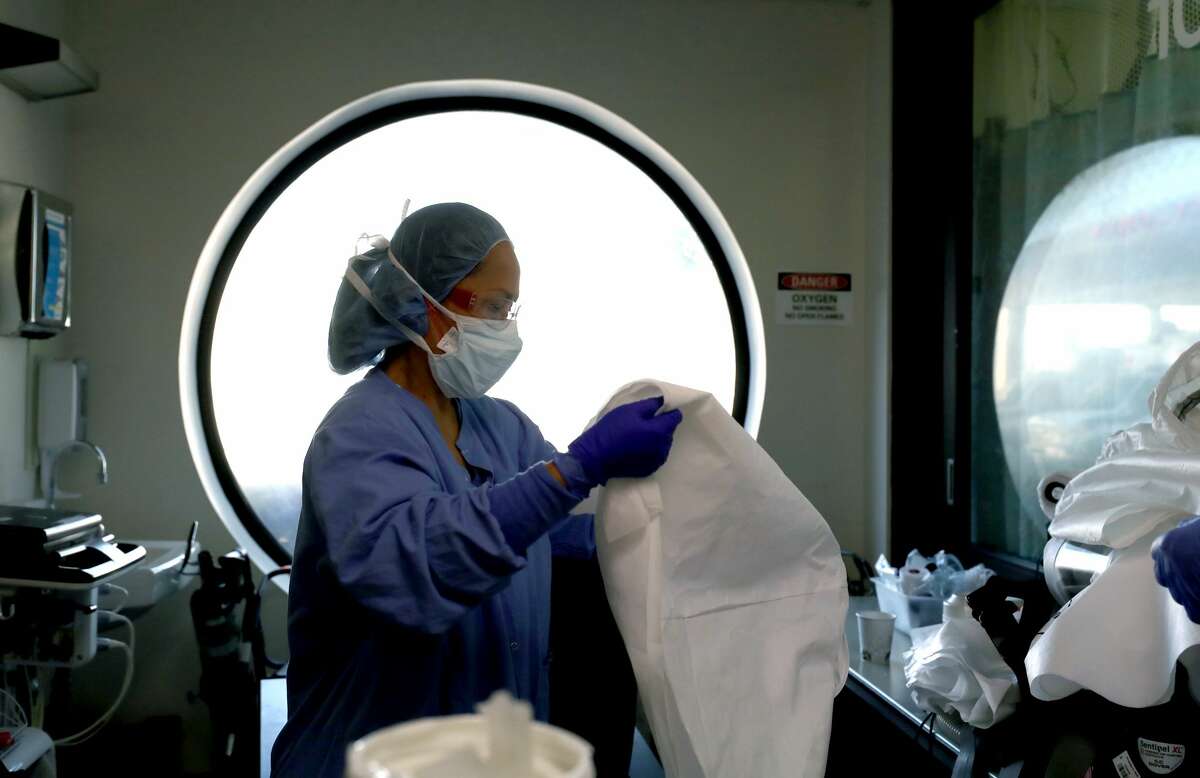 A nurse cleans personal protective equipment (PPE) after being part of a team that performed a procedure on a COVID-19 patient in the intensive care unit at Regional Medical Center in San Jose. Frontline workers are continuing to care for coronavirus patients throughout the San Francisco Bay Area. Santa Clara County, where this hospital is located, has had the most deaths of any Northern California county, and the earliest known COVID-19 related deaths in the United States.