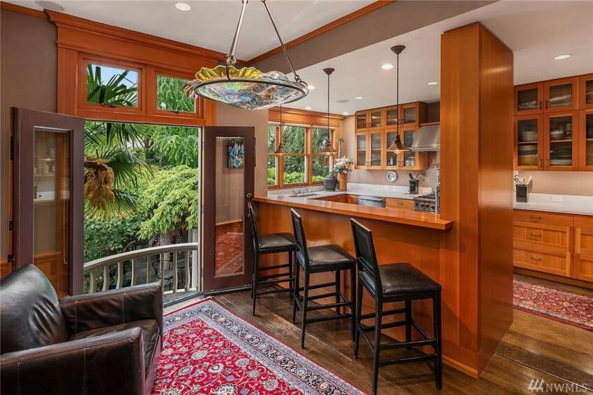The kitchen opens onto a view of lush grounds.