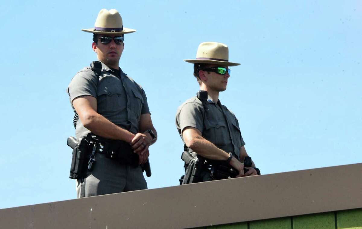 New York State Troopers are seen on top of the state police barracks as Shenendehowa High School students and others take part in a Black Lives Matter march from Clifton Common to the State Police barracks and back on Monday, June 8, 2020 in Clifton Park, N.Y. (Lori Van Buren/Times Union)