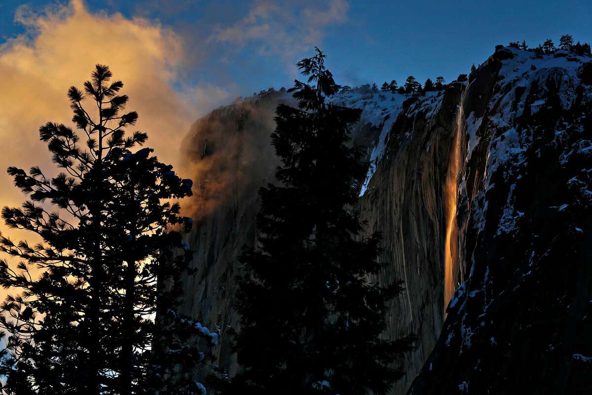 Horsetail Falls lights up from the setting sun against El Capitan in Yosemite National Park in Yosemite, Calif., on Monday, February 18, 2019. The popular lightshow is known as firefall and happens in the later weeks of February when the setting sun hits the waterfall.
