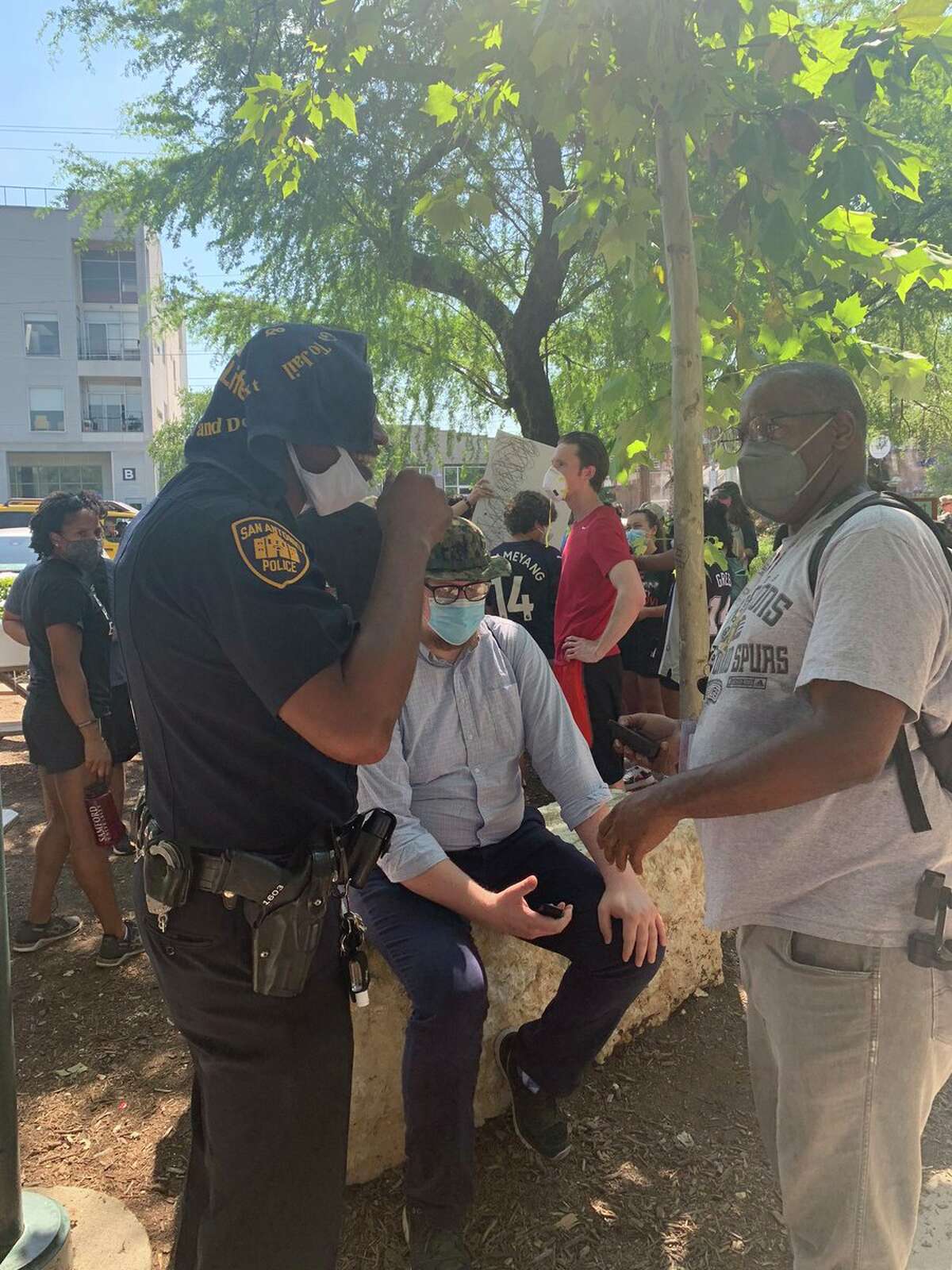 Officer Doug Greene, public information officer with the San Antonio Police Department, meets with protesters Monday, June 8, 2020, at Blue Star Arts Complex.