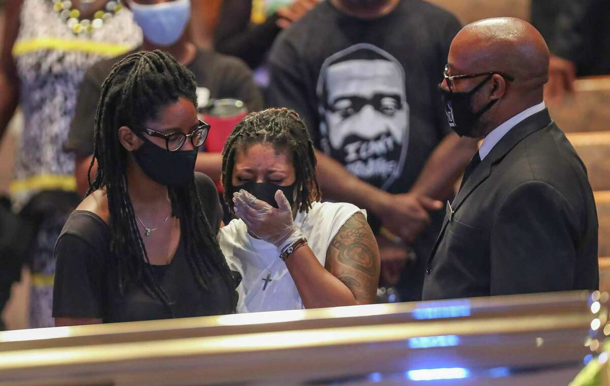 Mourners react as they view the casket of George Floyd during a public visitation Monday, June 8, 2020, at The Fountain of Praise church in Houston. Floyd died after being restrained by Minneapolis Police officers on May 25.
