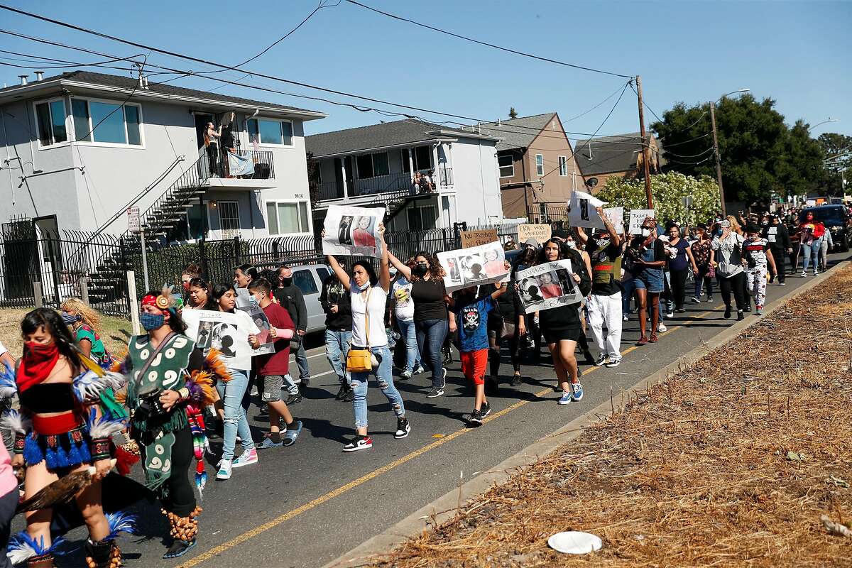 The family of Erik Salgado (center with signs) takes part in a protest march on Bancroft Avenue to memorialize Salgado, who was killed in a CHP officer-involved shooting Saturday night. Photographed in Oakland, Calif., on Monday, June 8, 2020.