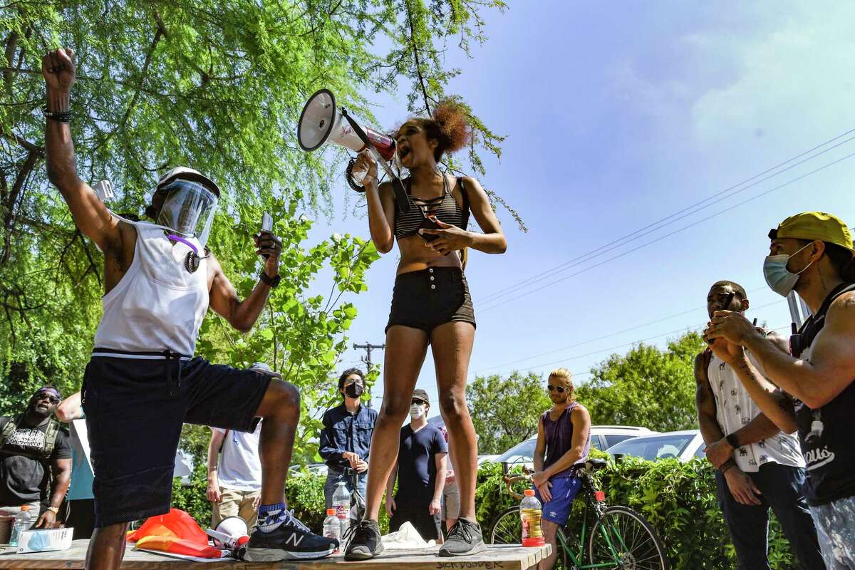 Lexi Qaiyyim recites "Still I Rise," a poem by Maya Angelou, during a protest at the Blue Star Arts Complex on Monday, June 8, 2020. People attending the event called for changes in policing and honored George Floyd, an African-American man who died at the hands of police in Minneapolis.