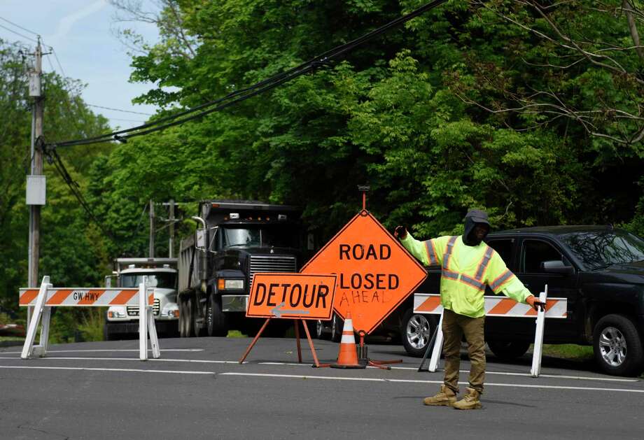 Traffic is redirected as Anderson Road is closed in Greenwich, Conn. Tuesday, May 19, 2020. Anderson Road will be closed again Wednesday between Elm Street and Mallard Drive as crews repair damage from the water main break. Photo: Tyler Sizemore / Hearst Connecticut Media / Greenwich Time