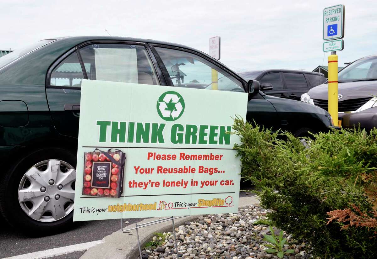 An environmental sign reminding shoppers to use their reusable bags is seen in the parking lot of ShopRite on Tuesday, June 9, 2020 in Albany, N.Y. Environmentalists are pushing the state to implement the plastic bag ban put off when the coronavirus hit. (Lori Van Buren/Times Union)