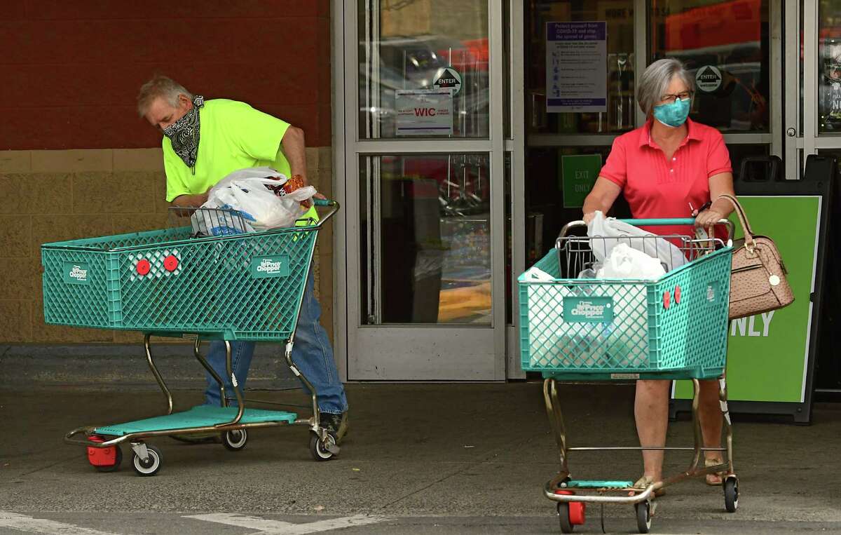 Shoppers leave the Price Chopper on Central Ave. with plastic bags in their carts on Tuesday, June 9, 2020 in Albany, N.Y. Environmentalists are pushing the state to implement the plastic bag ban put off when the coronavirus hit. (Lori Van Buren/Times Union)