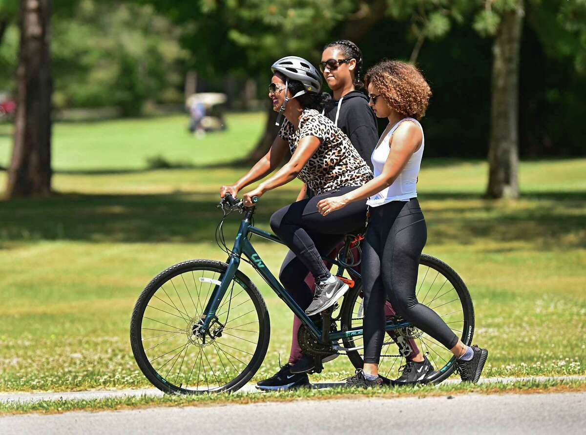 Liya Sisay of Brooklyn, right, helps her friend Tita Gashaw of New Jersey learn how to ride a bike in Saratoga Spa State Park on Tuesday, June 9, 2020 in Saratoga Springs, N.Y. The women, including one who wished not to be named, came upstate to get away and relax. (Lori Van Buren/Times Union)