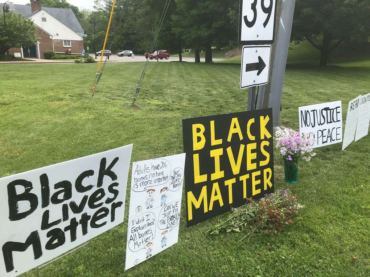 Signs supporting the Black Lives Matter movement in Sherman, Conn., before town officials announced ad-hoc signs at the intersection would be removed.