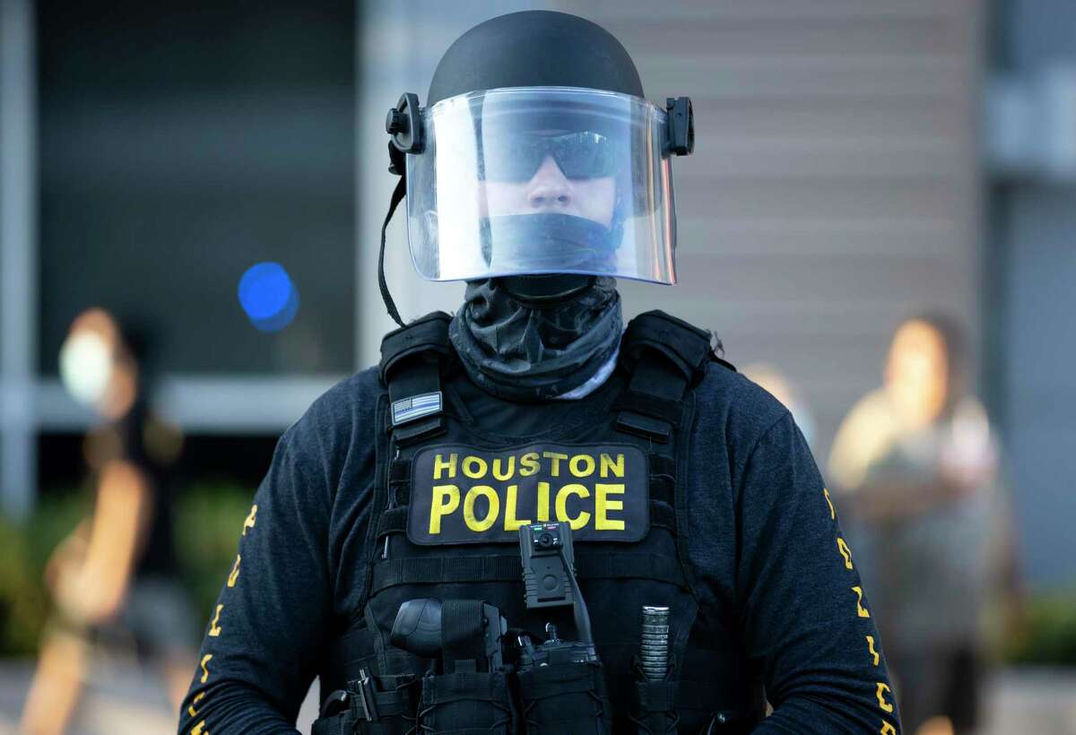 A Houston Police Department officer wears a face mask and shield during a protest held in downtown Houston, Tuesday, June 3, 2020. An estimated 60,000 people attended the rally in support of George Floyd and police reform.