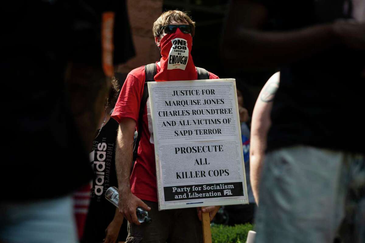 A protester holds up a sign outside the Paul Elizondo Tower Building in downtown San Antonio, Texas, on June 9, 2020. Protesters rallied a day after Bexar County District Attorney Joe Gonzales said he did not plan to reopen the cases of Marquise Jones, Charles Roundtree and Antronie Scott, all of whom were killed by San Antonio police officers.