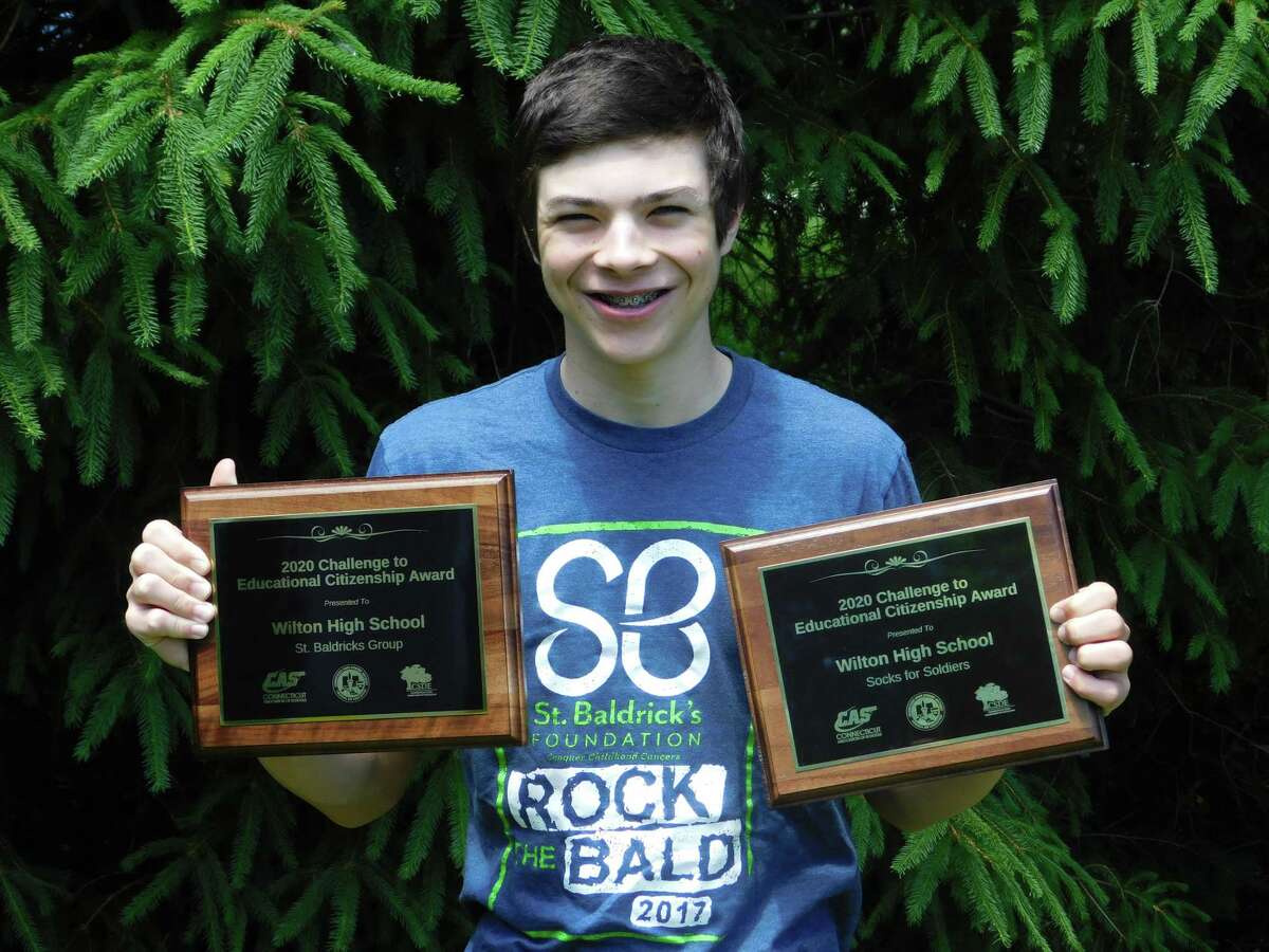 Wilton High School student Elijah Ackerman holds Connecticut Association of Schools awards for the Socks for Soldiers and St. Baldrick’s programs that were given out virtually on June 9.