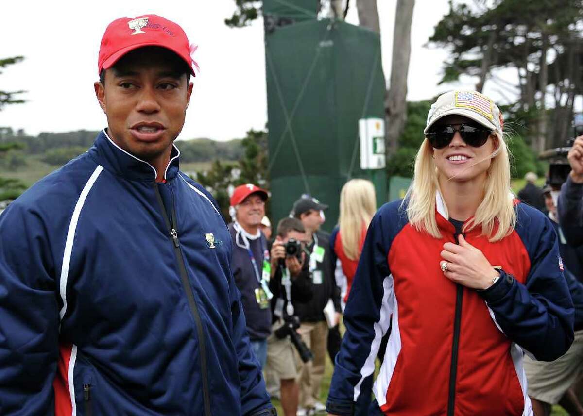 Tiger Woods and his wife Elin Nordegren talk on the golf course at the Pres...
