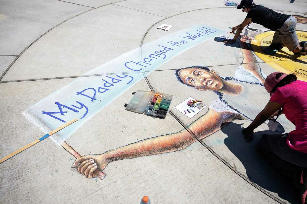 Claudia Cepeda & Hung N. Pham work on a chalk mural of George Floyd's 6-year-old daugter, Gianna, at Northshore Park in The Woodlands, Sunday, June 7, 2020. The mural took approximately six hours to complete with a crew of five artists.