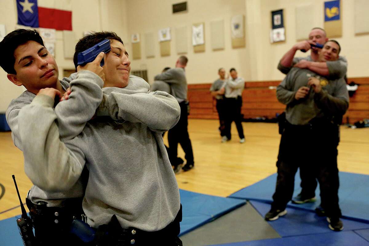 Jocelyne Alvarez, left, and Alyssa Hernandez participate in a training exercise at the San Antonio Police Training Academy on June 29, 2017. San Antonio police officers are allowed to place a suspect in a potentially deadly chokehold as a last resort, though the maneuver is not taught by instructors and it is highly discouraged.