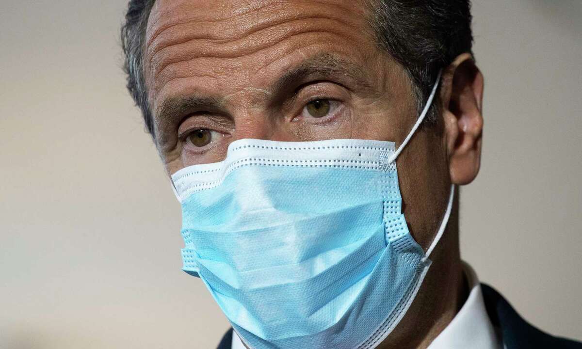 Gov. Andrew Cuomo wears a mask during a news conference at Laguardia Airport's Terminal B, Wednesday, June 10, 2020 in New York. The new terminal will open Saturday, June 13.