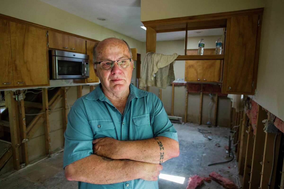 Michael Fernette poses for a portrait Wednesday inside the kitchen of his home on Saint Mary's Drive in Midland, which had to be gutted after the house flooded. Fernette and his neighbors received a statement from the City of Midland saying that if their homes were below the base flood elevation, they would need to bring the structures up to code. The Fernettes' home is two inches below the base flood level. (Katy Kildee/kkildee@mdn.net)
