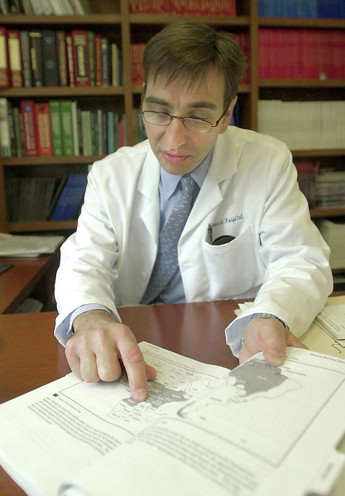 Dr. James Sabetta in his office at Greenwich Hospital, talks about vacinations when people travel the world.