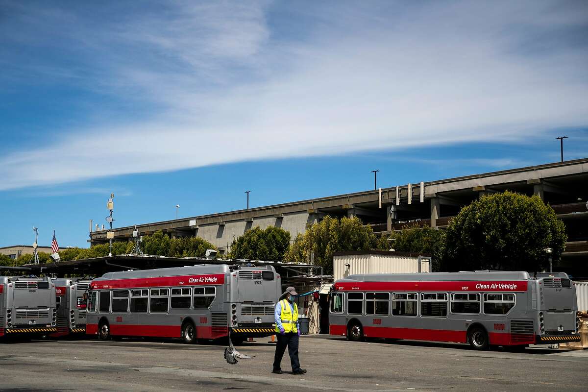 A Muni worker walks in the San Francisco Municipal Transportation Agency's Kirkland bus yard on Wednesday, June 10, 2020 in San Francisco, California