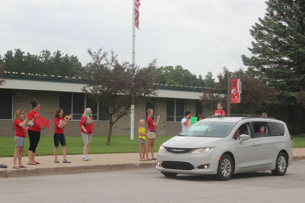 Crystal Lake Elementary staff members cheer on their fifth graders during an end of the school year parade at Benzie Central High School.