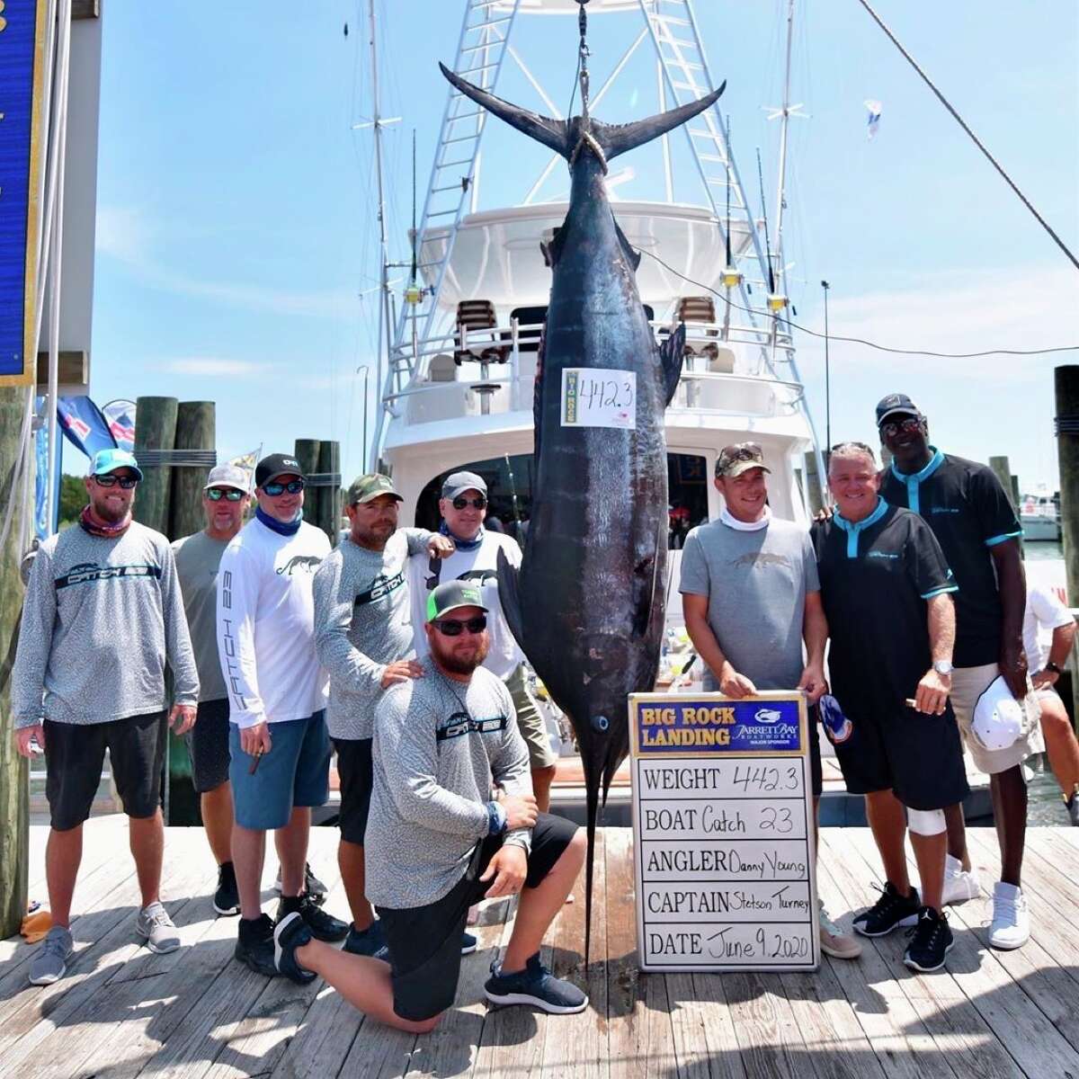 In a photo provided by Grace Bell, Michael Jordan, right, and the crew of his 80-foot fishing boat named aCatch 23a pose after hauling in a 442.3-pound blue marlin Tuesday, June 9, 2020, at the Big Rock Blue Marlin Tournament in Morehead City, N.C. (Grace Bell via AP)