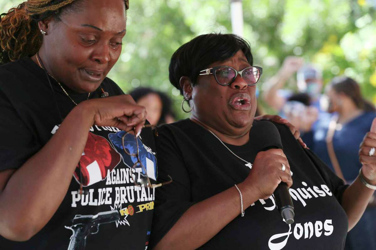 Cheryl Jones, left, and Debbie Bush get emotional while addressing protesters gathered Wednesday. They were demanding the reopening of the Marquise Jones and Charles Roundtree cases.